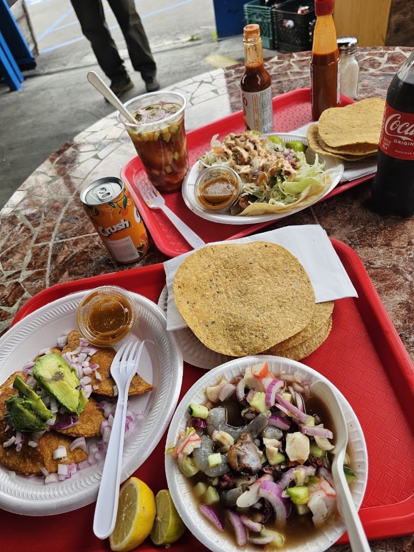 Colorful mariscos dishes in a relaxed setting.
