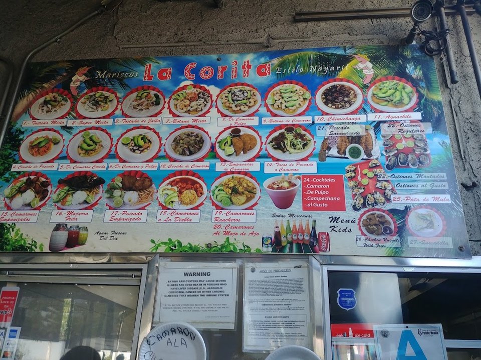 Menu page showing empanadas and shrimp dishes.